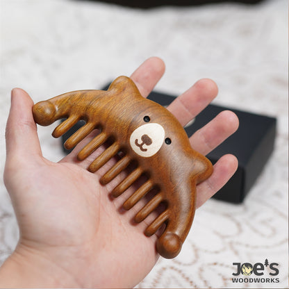 Cute bear-shaped wooden massage comb held in hand – Joe&