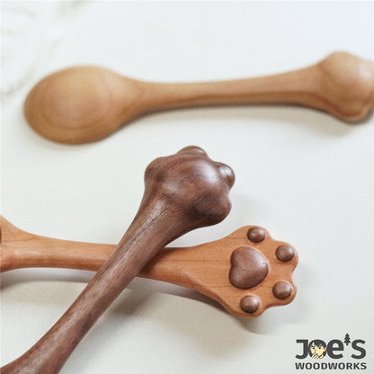 Close-up of the cat paw-shaped spoon handles showing the back view