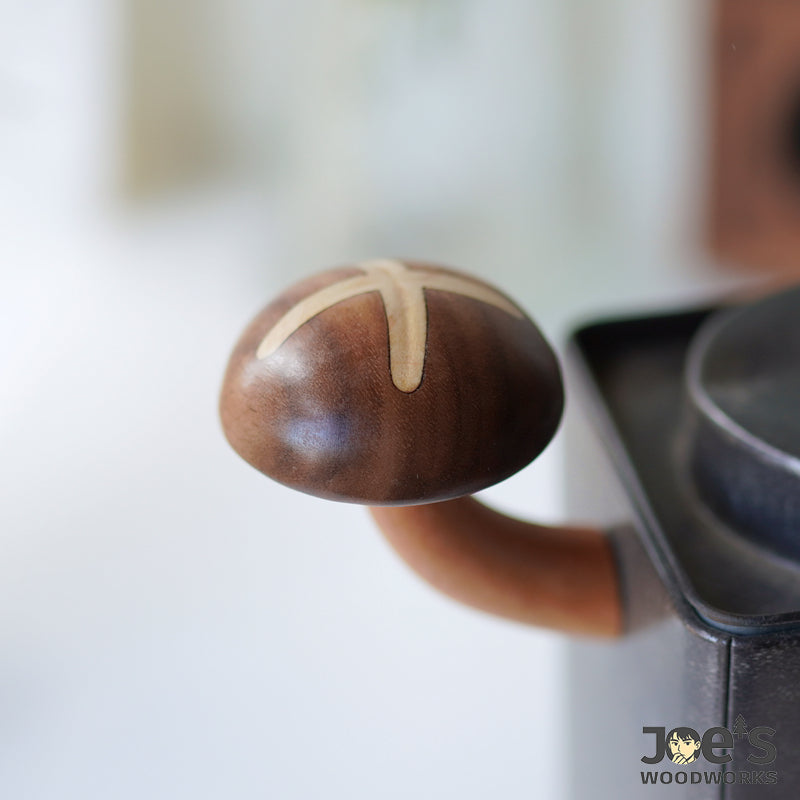 Close-up of blooming shiitake mushroom-shaped wood magnet on fridge corner