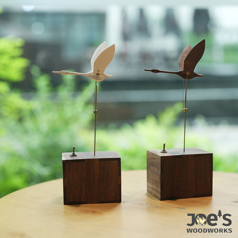 White and brown swan automata displayed on tabletop