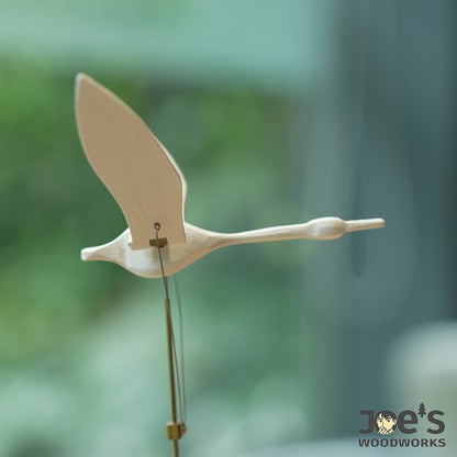 Close-up of white wood swan with brass mechanism