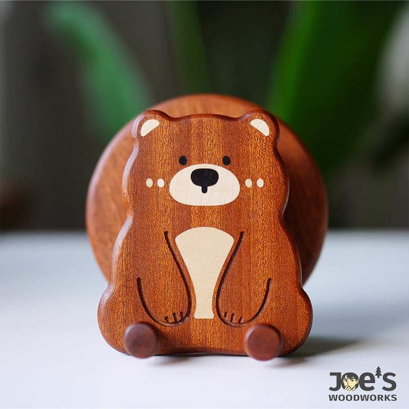 Close-up front view of bear face design on wooden phone holder