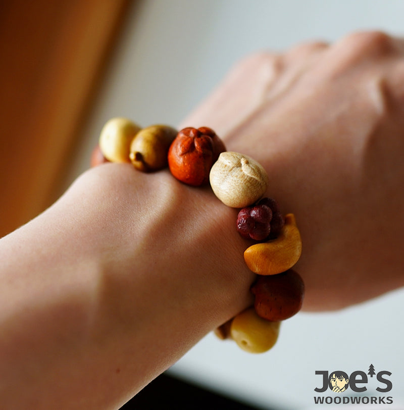 Colorful wooden fruit bead bracelet worn on wrist