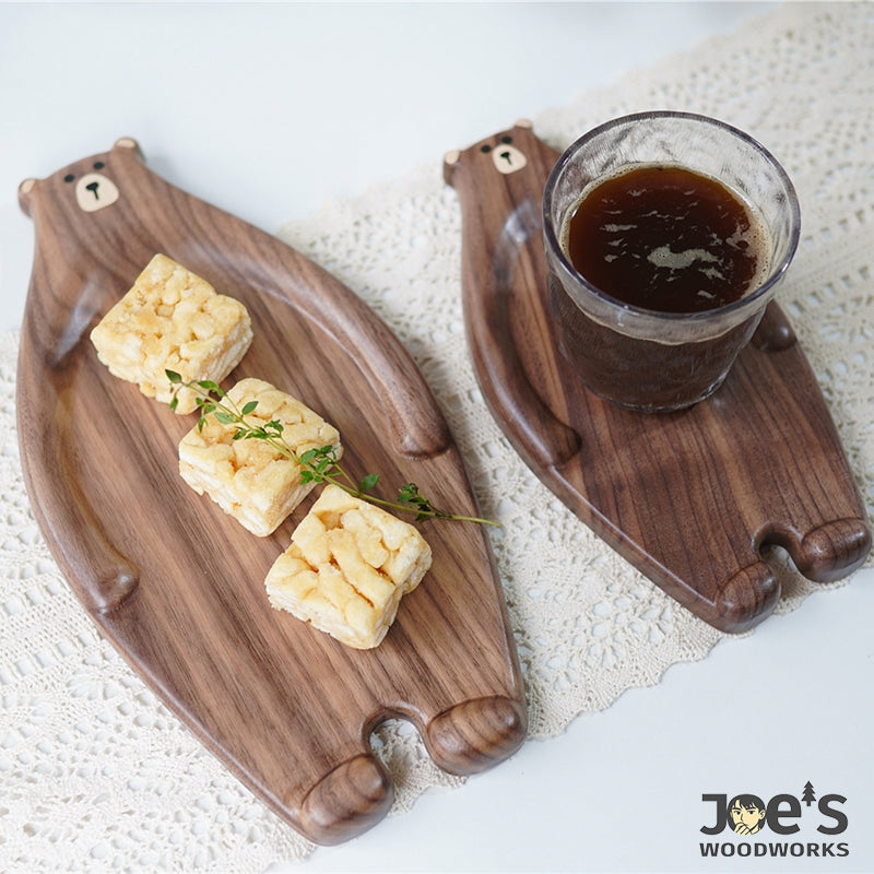 Komi Bear trays used for serving pastries, coffee, and fruit on a cozy table