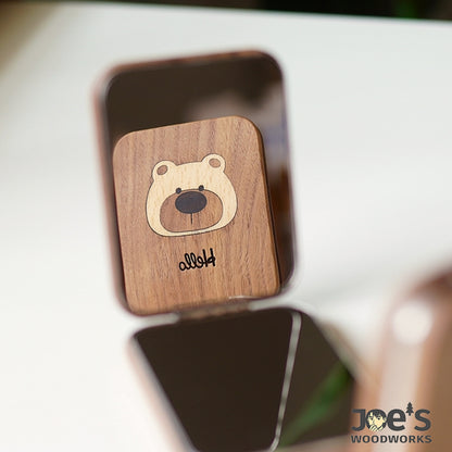 Close-up of Lumi Bear mirror’s carved Hello message and wood texture