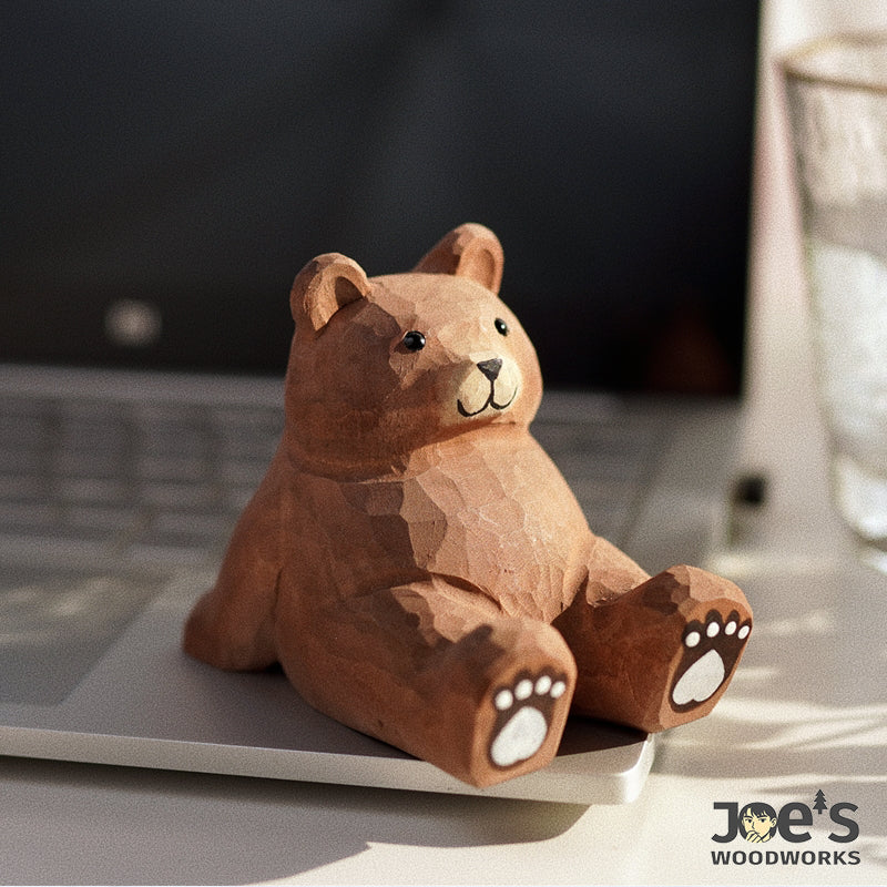 Joe’s Woodworks hand-carved wooden bear phone stand on desk, cute and functional