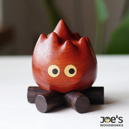 Front view of the fire flame figurine resting on its wooden base