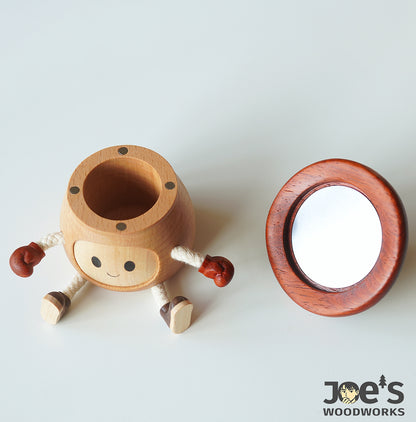 Wooden mushroom doll with separate cap revealing built-in compact mirror