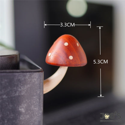 Wooden mushroom fridge magnet with height and width measurements shown