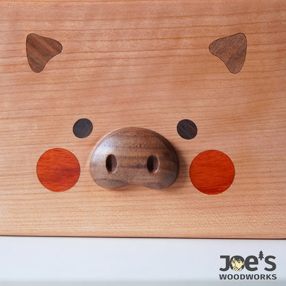 Close-up of piglet snout with walnut wood carving
