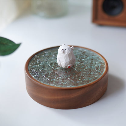 Side view of Pipimu Bear Jar with white bear figurine on walnut wood and glass lid