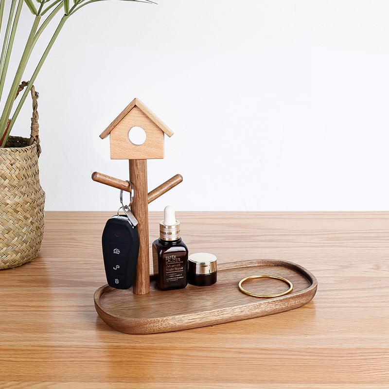 Wooden birdhouse tray organizer in walnut with keys and jewelry on entryway table