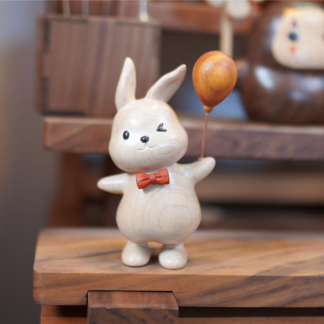 Pipimu Bunny Ruby holding a wooden balloon