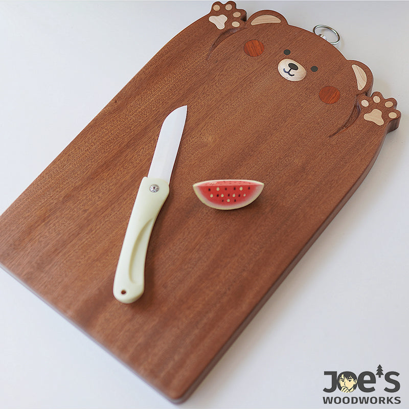 Pipimu Chopi Bear hand-carved wooden cutting board front view with bear face design