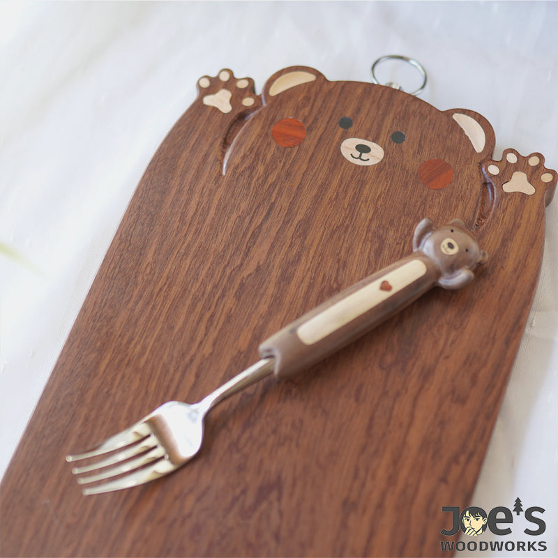 Side view of Pipimu Chopi Bear cutting board showing smooth walnut grain