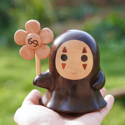 Nordic-style Mori Forest Spirits wooden figurine, artisan carved with lucky coin design in hand.