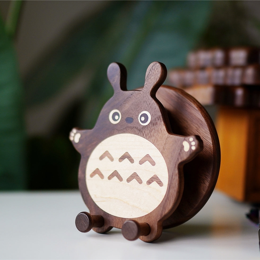 Handmade wooden Totoro-inspired phone holder side angle