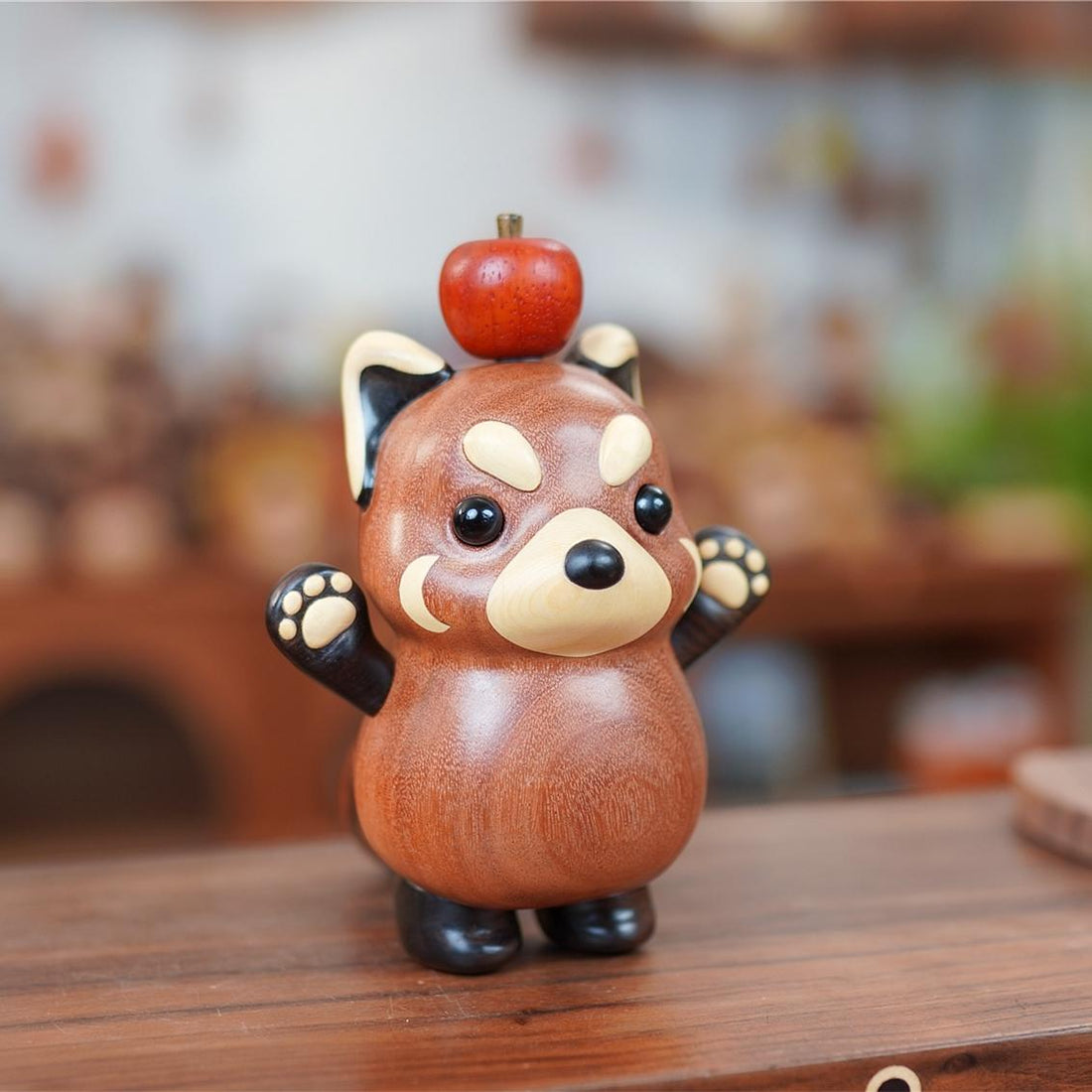 Handmade wooden red panda figurine with apple on head by pipimu