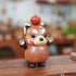 Handmade wooden red panda figurine with apple on head by pipimu