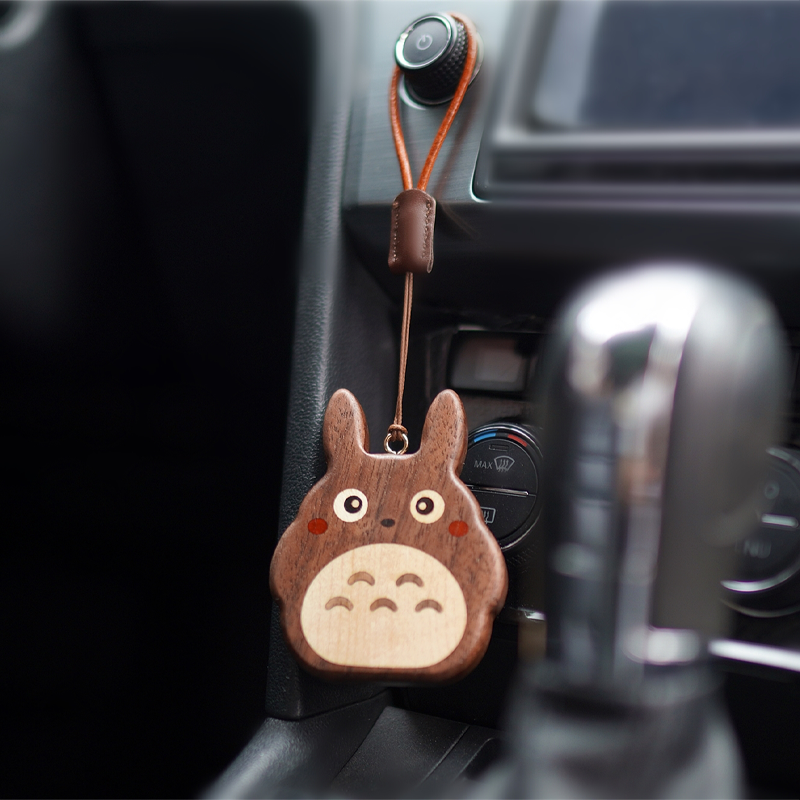 Kumo Forest Spirits wooden hanging charm by Pipimu on car dashboard