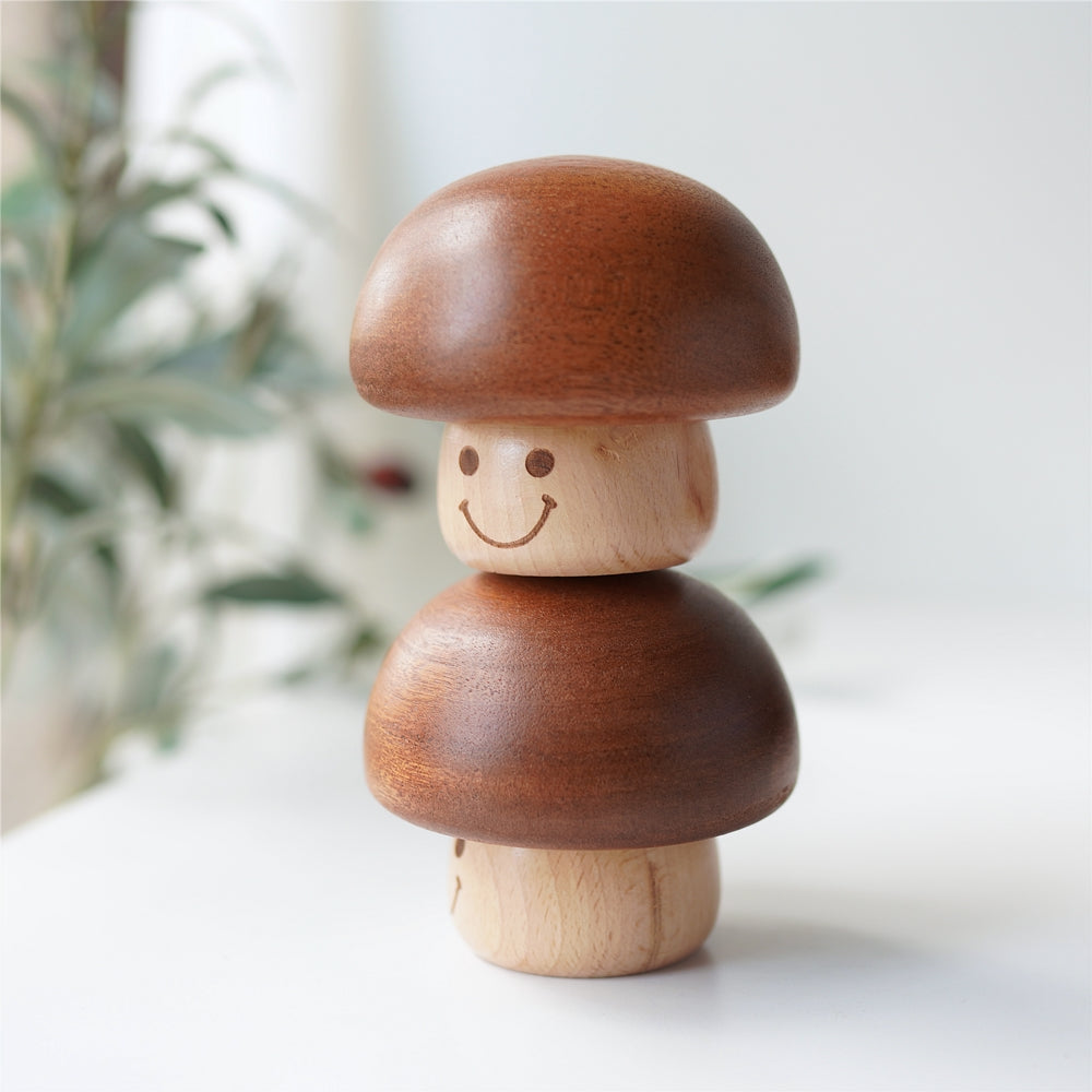 Two wooden mushroom music boxes stacked for display
