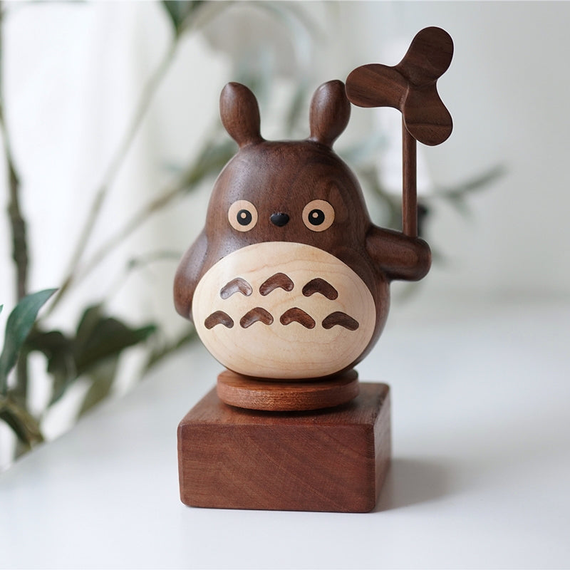 Pipimu wooden music box base with forest spirit figurine on top, versatile ebony display stand