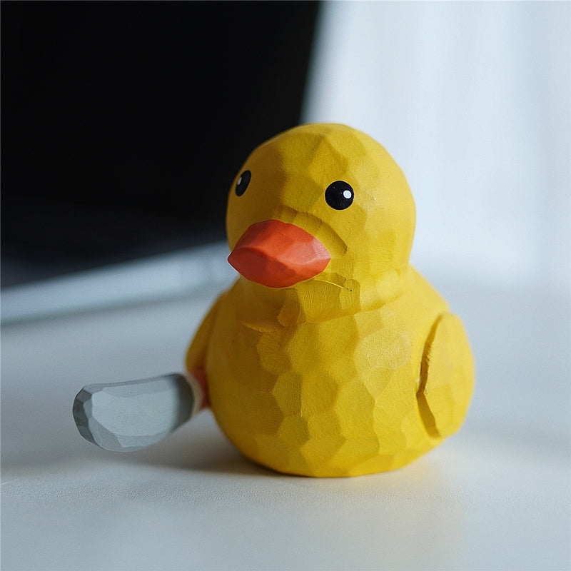 Hand-carved wooden yellow duck figurine front view