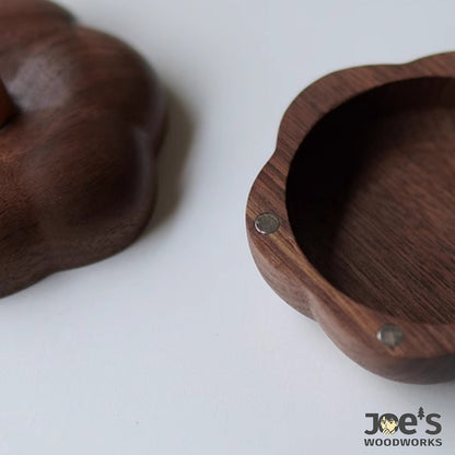 Detail of magnet and woodgrain texture inside the hand-carved wooden pumpkin box lid