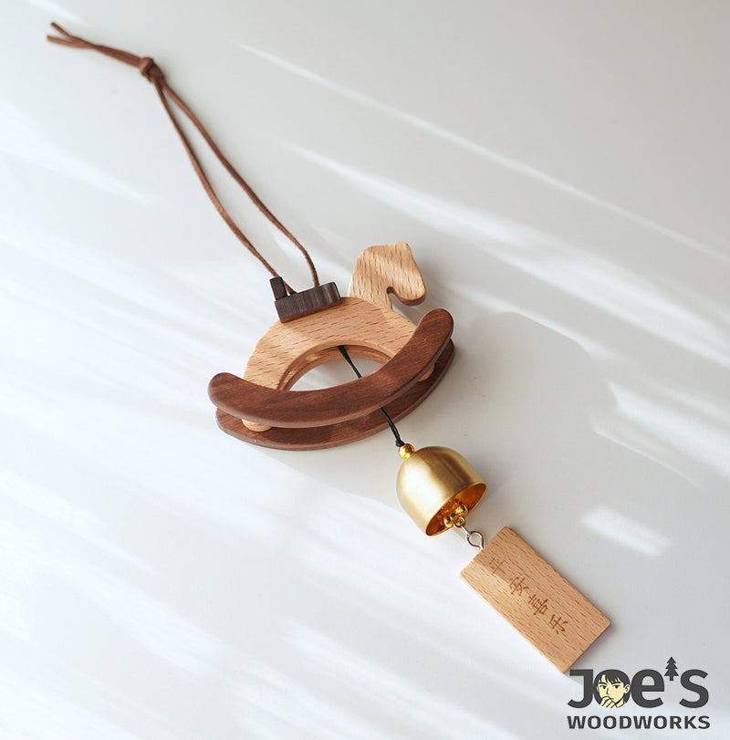 Close-up of wooden rocking horse wind chime with delicate carving and smooth finish