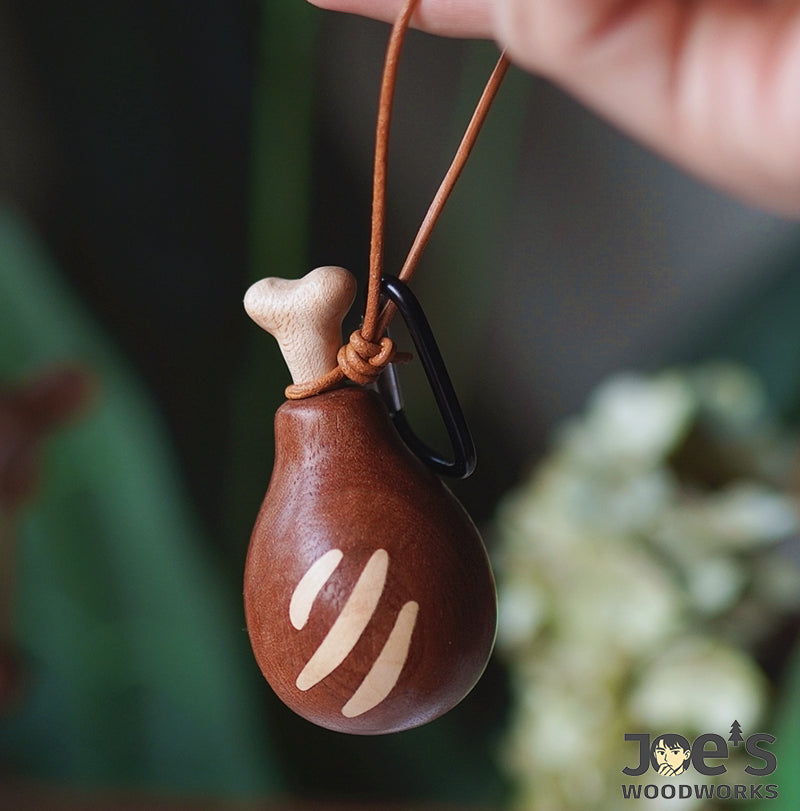 Chicken leg-shaped wooden keychain with leather loop and metal clip for hanging