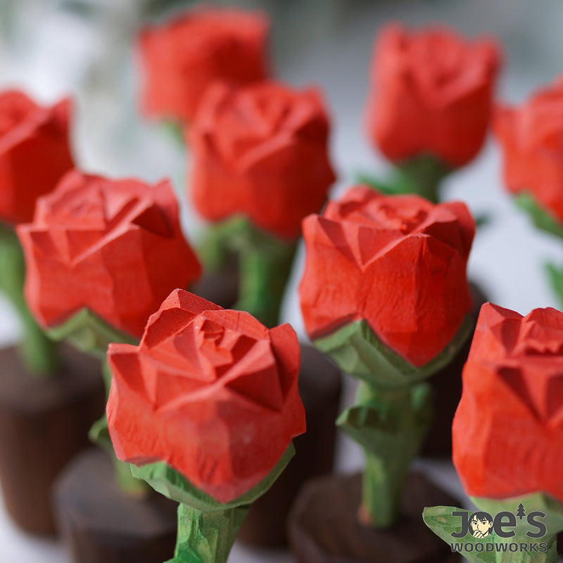 Close-up of multiple handcrafted wooden rose flowers, natural red finish
